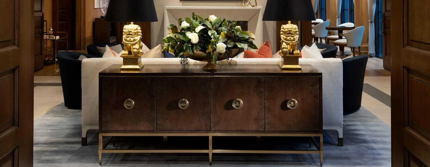 Lobby has a large credenza behind plush couches
