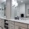 Bathroom has two sinks and a large rain showerhead in a glass walk-in shower