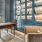A home den has floor-to-ceiling windows and a built-in library