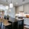 Spacious kitchen features a kitchen island and overhead pendants